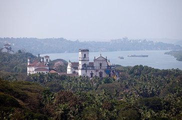 Aerial panoramic view Old Goa. Mandovi river and ancient Churche - obrazy, fototapety, plakaty