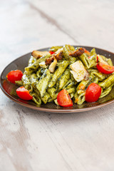 Penne cooked cereal specialty with cooked chicken fillets and a sauce made with olive oil