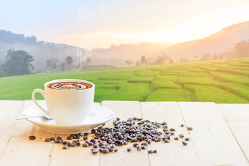 hot coffee with rice terrace view on background / hot cappuccino with nice view landscape