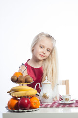 Little girl sitting at the table