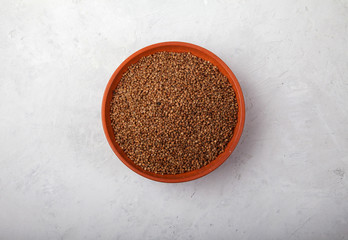 buckwheat in a clay bowl on a white background. superfood