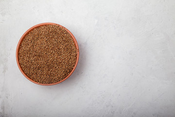 buckwheat in a clay bowl on a white background. superfood