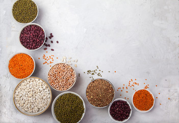 Red and white beans, green and red lentils, sunflower and pumpkin  in cups on a white background. superfood