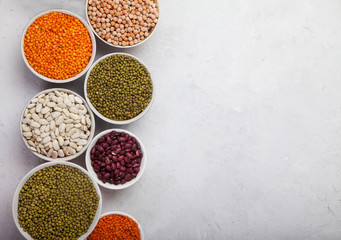 Red and white beans, green and red lentils, sunflower and pumpkin  in cups on a white background. superfood