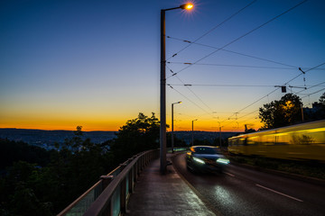 Germany, Traffic of cars and tram of city stuttgart after sunset in summer from above in magical twilight atmosphere