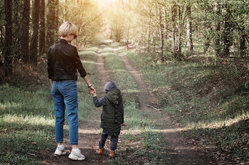 mother walks with her child in the forest