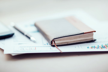 notebook and financial chart on the office Desk