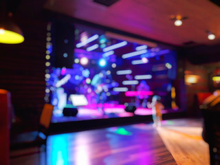 Scene with light, musicians on stage in the rock-cafe. Blur effect
