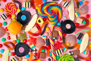 Fototapeta na wymiar background of lollipops and candies on pink