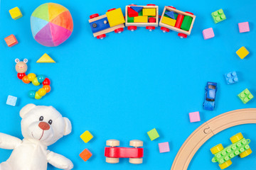 Colorful kids toys frame on blue background. Top view. Flat lay