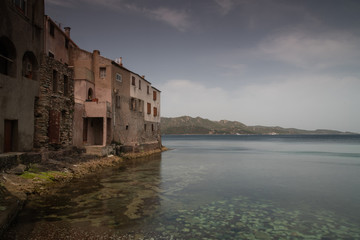 Fototapeta na wymiar Houses built near the water, in the village of Saint Florent, Corsica