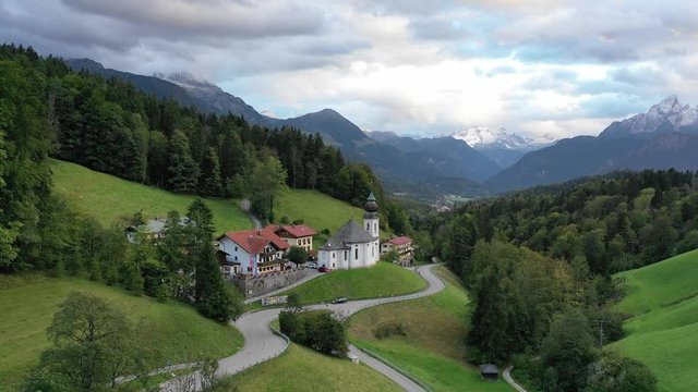 Aerial shot flying over the famous pilgrimage church of Maria Gern in Berchtesgaden Bavaria, Germany and the surrounding landscape