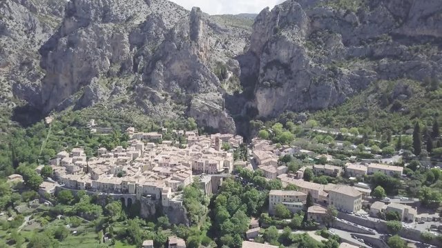 Drone flying dolly out reveal village of Moustiers at the bottom of Notre Dame ravine.