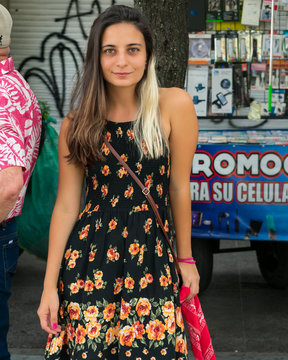 Woman in black short dress with orange flowers