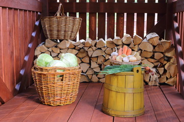 Fresh vegetables on the yellow tub in a wooden shed.