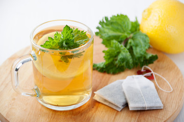 Green tea with mint and lemon in a glass mug