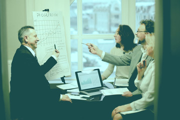 confident businessman showing business partners a new commercial