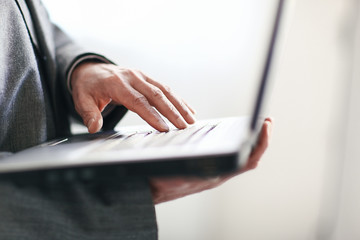 close up.businessman typing on a laptop keyboard.isolated on white background