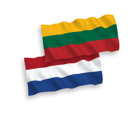 National vector fabric wave flags of Lithuania and Netherlands isolated on white background. 1 to 2 proportion.