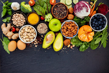 Ingredients for the healthy foods selection. The concept of healthy food set up on dark stone background.