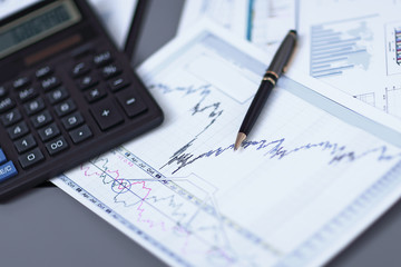 Naklejka na ściany i meble close up.pen, financial chart and calculator on the businessman's Desk