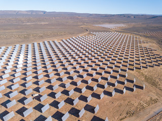 Fototapeta premium Aerial over solar panels in a dry landscape