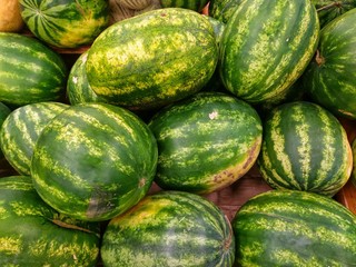 Ripe watermelons on a shop counter, texture and background