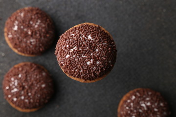Chocolate Crinkle cookies. close-up of Crinkle cookies chocolate biscuits on Christmas cookies on a black plate, view from above.