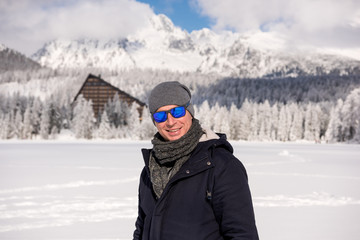 Fototapeta na wymiar Portrait of young man in winter mountains