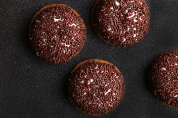 Chocolate Crinkle cookies. close-up of Crinkle cookies chocolate biscuits on Christmas cookies on a black plate, view from above.