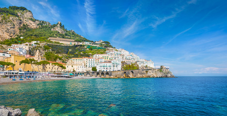 Beautiful Amalfi on hills leading down to coast, comfortable beaches and azure sea on Amalfi Coast in Campania, Italy