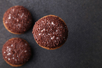 Chocolate Crinkle cookies. close-up of Crinkle cookies chocolate biscuits on Christmas cookies on a black plate, view from above.