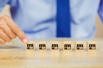 Franchise business concept , businessman hand choose wood blog with franchise marketing.