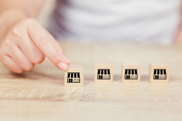Franchise business concept , woman hand choose wood blog with franchise marketing.