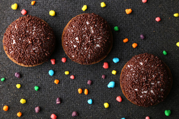 Chocolate Crinkle cookies. close-up of Crinkle cookies chocolate biscuits on Christmas cookies on a black plate, view from above.