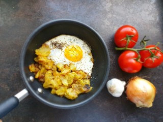 fried eggs with bacon and vegetables