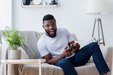 Young man playing video games at home