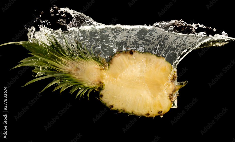 Poster pineapple half splashing into water with drops
