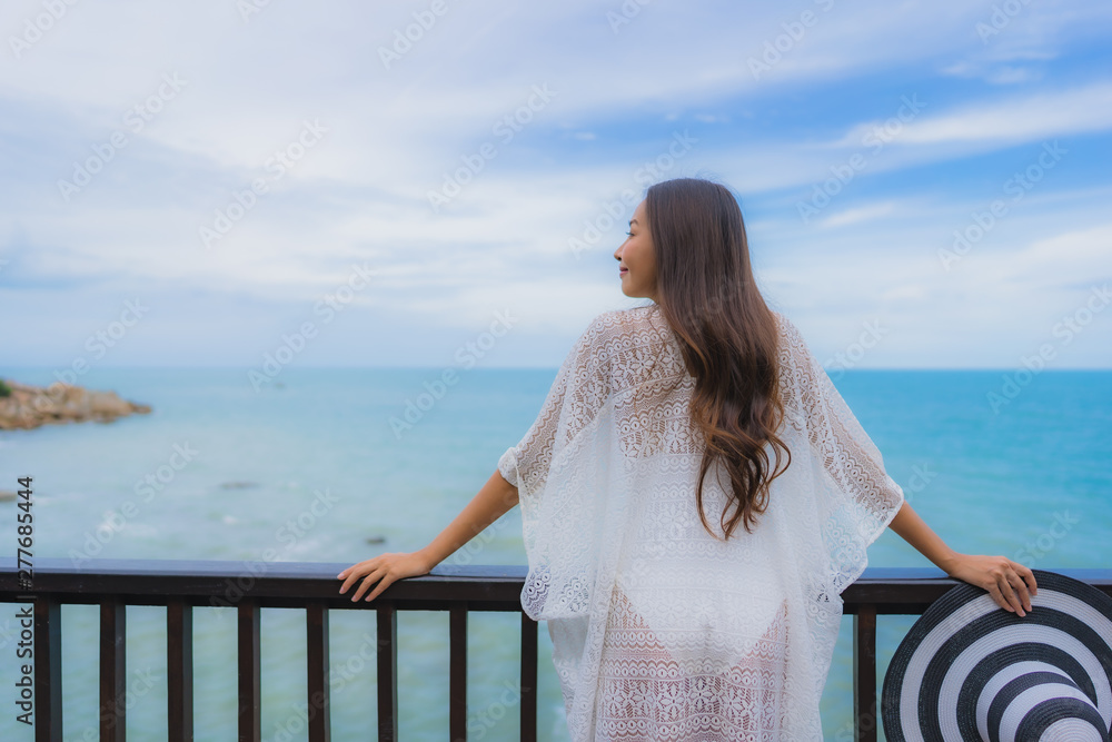 Wall mural portrait beautiful young asian woman looking sea beach ocean for relax in holiday vacation travel