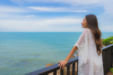 Fototapeta na wymiar Portrait beautiful young asian woman looking sea beach ocean for relax in holiday vacation travel