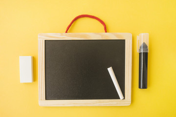 Marker and eraser near blackboard and chalk