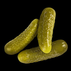 Marinated pickled cucumbers, isolated on black background