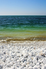 Green waves of the sea lapping on the shore