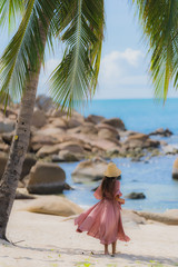 Portrait young asian woman smile happy around beach sea ocean with coconut palm tree for holiday vacation