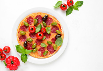Pizza with salami and olives, top down view