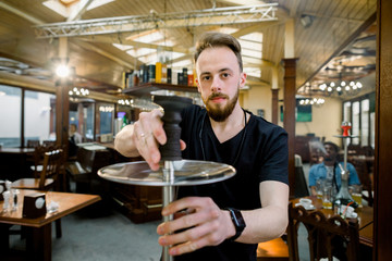 Hookah Server Waiter Prepares A Shisha Pipe For Smoking