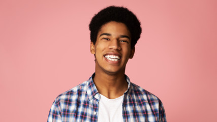Perfect Teeth. African-American Guy Widely Smiling in Studio