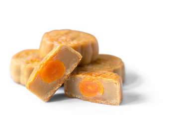 moon cakes in a Chinese mid-autumn festival cut in a half to see soy bean and egg yolk stuff inside on white background