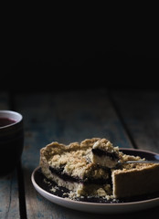 Low key food photo of Blueberry pie with cup of tea on wooden table