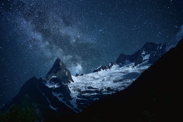 night sky with stars Milky Way over the mountains of the Caucasus, Dombay, peak Ine
